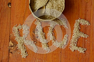 Rice in vintage bowl with vintage teaspoon on wooden background, reis, arroz, riso, riz, Ñ€Ð¸Ñ.